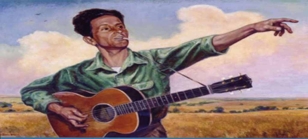 Woody Guthrie with guitar